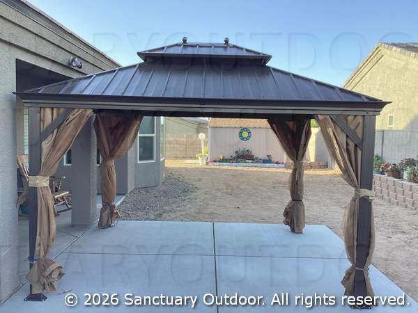 Screened in steel pergola over concrete patio, side view
