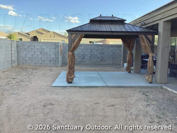 Steel pergola with privacy curtains over concrete patio, side view